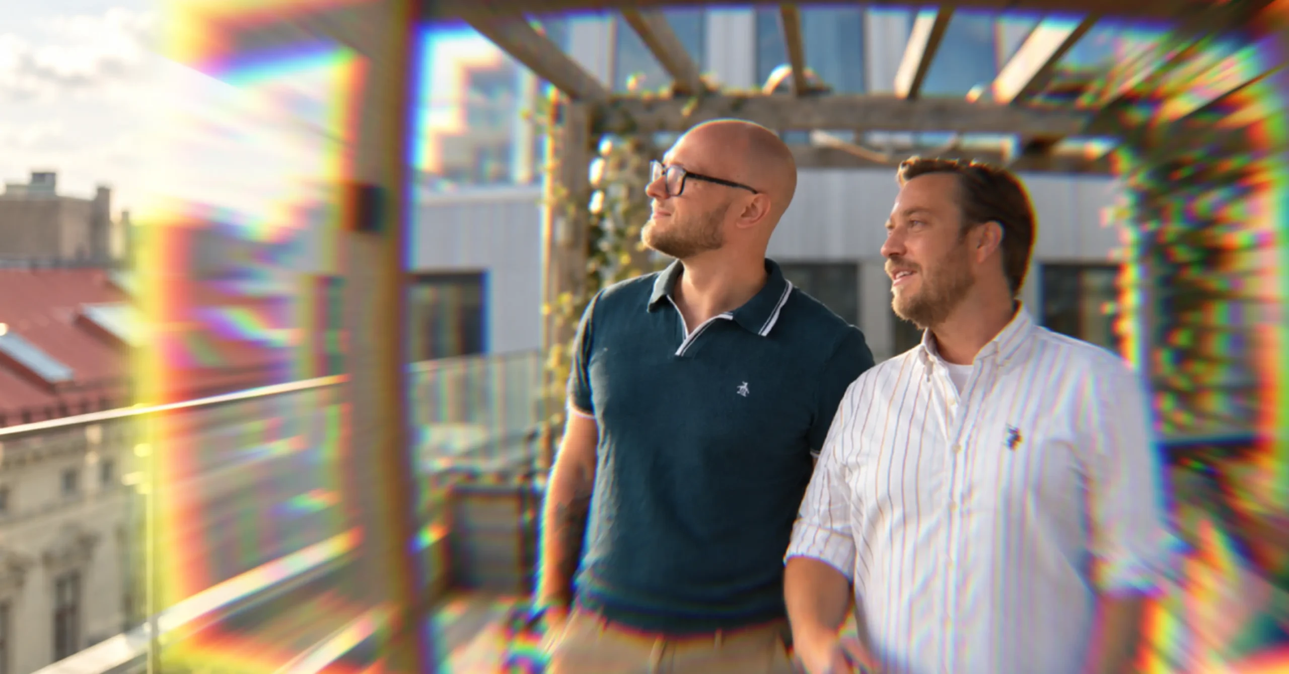 Fredrik Björkeroth and a colleague on a rooftop terrace, looking out over the city